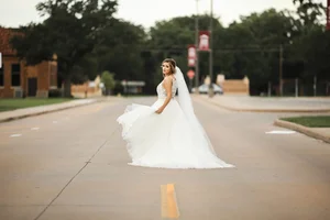 Bride crossing street in urban Denton Texas